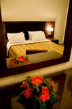 Reflection of a double bed at Onira Boutique/Hotel